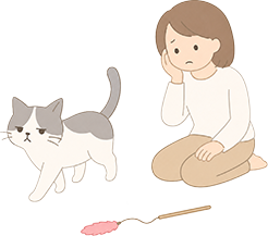 猫じゃらしに見向きもしない猫と、困り顔で見守る女性のイラスト
